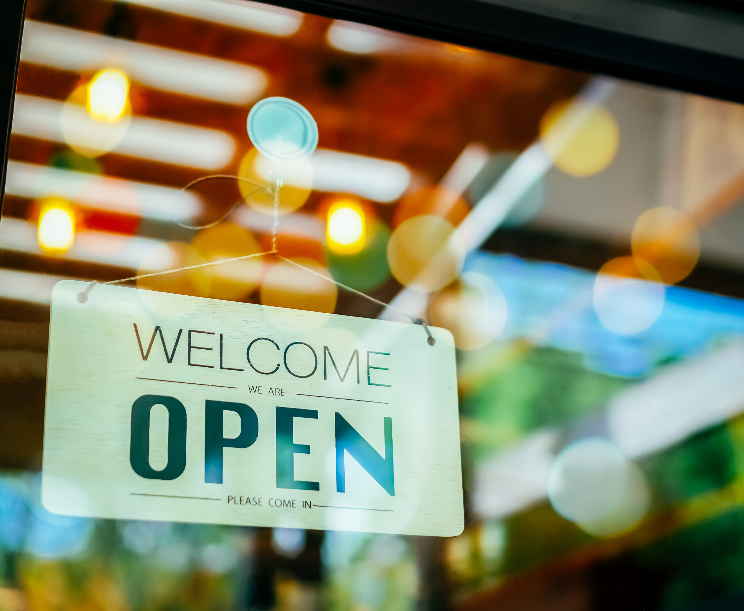 "Open” sign hanging in a restaurant window.
