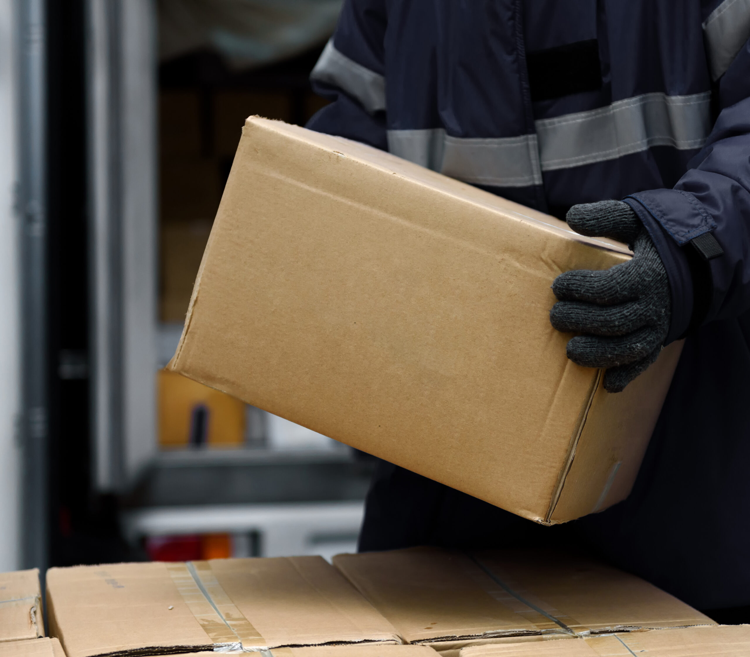 Worker handling a boxed shipment in a CORE warehouse.